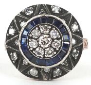 An 8ct rose gold diamond and sapphire target design three tier ring, total diamond weight 0.50