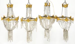 A set of four early 20th century gilt metal ceiling lights with cut glass drops, 75cm high x 36cm in