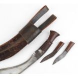 A vintage Gurkha's kukri knife with leather sheath and side knives, 45cm in length.