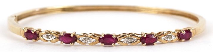 A 9ct gold ruby and diamond bangle, 6.5cm wide, 7.3g.