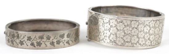 A Victorian silver bangle with engraved floral decoration, Birmingham 1876 together with a similar