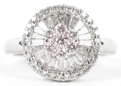 An 18K white gold diamond cluster ring, total diamond weight 1.08 carat, size O/P, 5.2g.