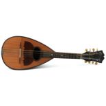 An early 20th century rosewood mandolin with bone tuning handles and mother of pearl fret markers,