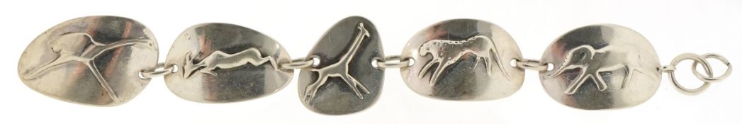 A South African sterling silver panel bracelet embossed with stylized animals, 18.5cm in length,