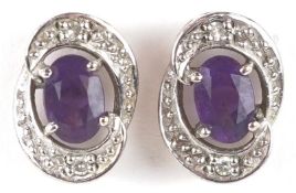 A pair of 9ct white gold diamond and amethyst stud earrings, 1.1cm high, total 2.3g.