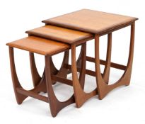 A G Plan teak nest of three occasional tables raised on shaped supports, 51cm H x 51cm W x 49cm D.