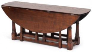A 20th century oak drop flap coffee table raised on turned and block supports, 48cm H x 123cm W x