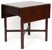 An late George III mahogany drop flap side table fitted with a drawer, raised on block legs united