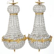 A pair of gilt metal and cut glass ceiling lights, 68cm high.