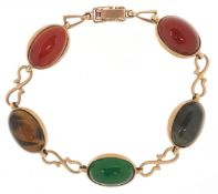 A 9ct gold multi gem panel bracelet including tiger's eye and carnelian, 19cm in length, 16.9g.