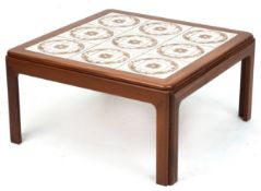 A mid 20th century teak square coffee table, the top inset with tiles, raised on block legs, 37cm