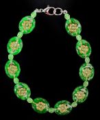 A uranium glass bead bracelet with floral design, 19cm in length, 14.1g.