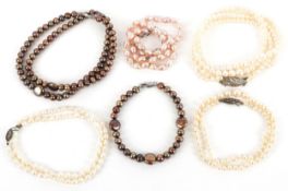 Five freshwater pearl necklaces and a bracelet, one with certificate, some with silver clasps, total