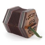 An early 20th century twenty button concertina with pierced fretwork, 16cm in diameter.
