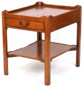A late 20th century mahogany two tier galleried side table fitted with a drawer, raised on block