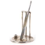 Edward Victor Stanley, a silver cricket bat and stumps on a planished base, London 1995, 7cm high,