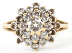 An 18ct gold diamond four tier cluster ring, the central diamond approximately 3.80mm in diameter,