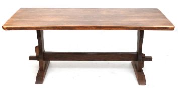 A 20th century oak refectory table, the rectangular top raised on shaped supports and bracket