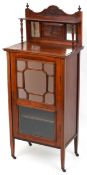 A late Victorian mahogany music cabinet, the shelf back above a mirrored and glazed door, on