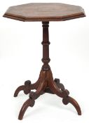 A 19th century mahogany octagonal wine table, the top carved with a floral band, raised on down