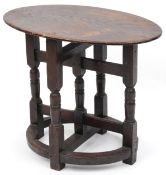 A late Victorian oak oval occasional table raised on turned and block supports, 59cm H x 72cm W x