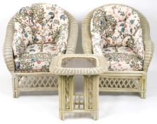 A modern grey painted wicker conservatory suite comprising a two seat sofa, four armchairs and a