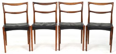 A set of four mid 20th century Danish rosewood dining chairs, each with black leather seat, raised