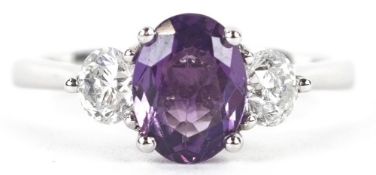 A platinum purple sapphire and diamond trilogy ring, total diamond weight 0.57 carat, the sapphire