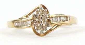 A 9ct gold diamond cluster ring with diamond set shoulders, size R, 2.6g.