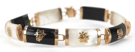 A Chinese 9K gold mother of pearl and onyx panel bracelet, 18.5cm in length, 11.0g.
