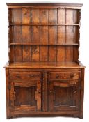 A 20th century oak dresser, the shelf back above two drawers and a cupboard, on stile supports,