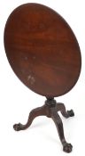 A late 19th century mahogany circular tip top wine table, the dished top raised on a turned