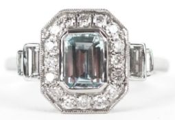 An Art Deco style platinum aquamarine and diamond cluster ring with baguette cut diamond stepped