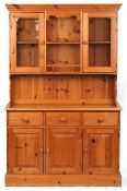 A late 20th century pine dresser, the shelf back fitted with a pair of glazed doors above three