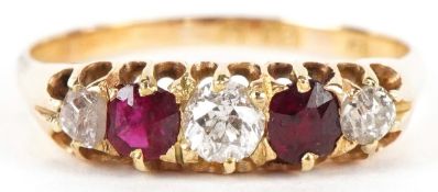 An 18ct gold diamond and pink spinel five stone ring, size O, 2.4g.