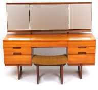 A mid 20th century teak kneehole dressing table and matching stool by Uniflex Furniture, the