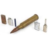 Sundry items including a military interest ammunition shell and five vintage pocket lighters, the