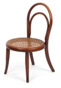 An early 20th century child's bentwood chair by Thonet, the cane seat raised on tapering legs,