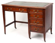 An Edwardian mahogany single pedestal desk, the top inset with a green leather writing surface above