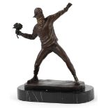 After Banksy, a patinated bronze study of The Flower Thrower raised on a black marble base, 26cm