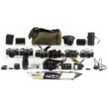 A collection of vintage cameras with lenses including Pentax MV, Yashica M-II, Olympus OM 10 and