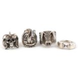 Four silver rings including a winged pig, a dragon and a skull, various sizes, total 73.6g.