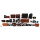 Collection of vintage cameras and box cameras including Kodak Brownie 127, Kodak Retinette, Kodak