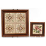 Set of four antique pottery tiles within a wood frame together with a similar example, the largest