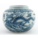 Chinese porcelain blue and white vase hand painted with dragons amongst clouds above waves,