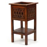Mexican pine plant stand having pierced panels above an under tier, 72.5cm H x 38.5cm W x 38.5cm D.