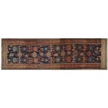 Persian carpet runner having an all over geometric design on a blue ground, 430cm x 125cm