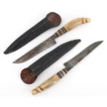 Two vintage German horn handled daggers and leather sheaths, the blades engraved Solingen, 26cm in