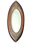 LATE VICTORIAN OVAL OAK AND BRASS WORKED MIRROR