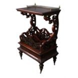 A Victorian mahogany Canterbury, the top on pierced scrollwork supports and enclosing three